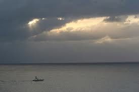 boat as metaphor for riding: calm sea, stormy sky